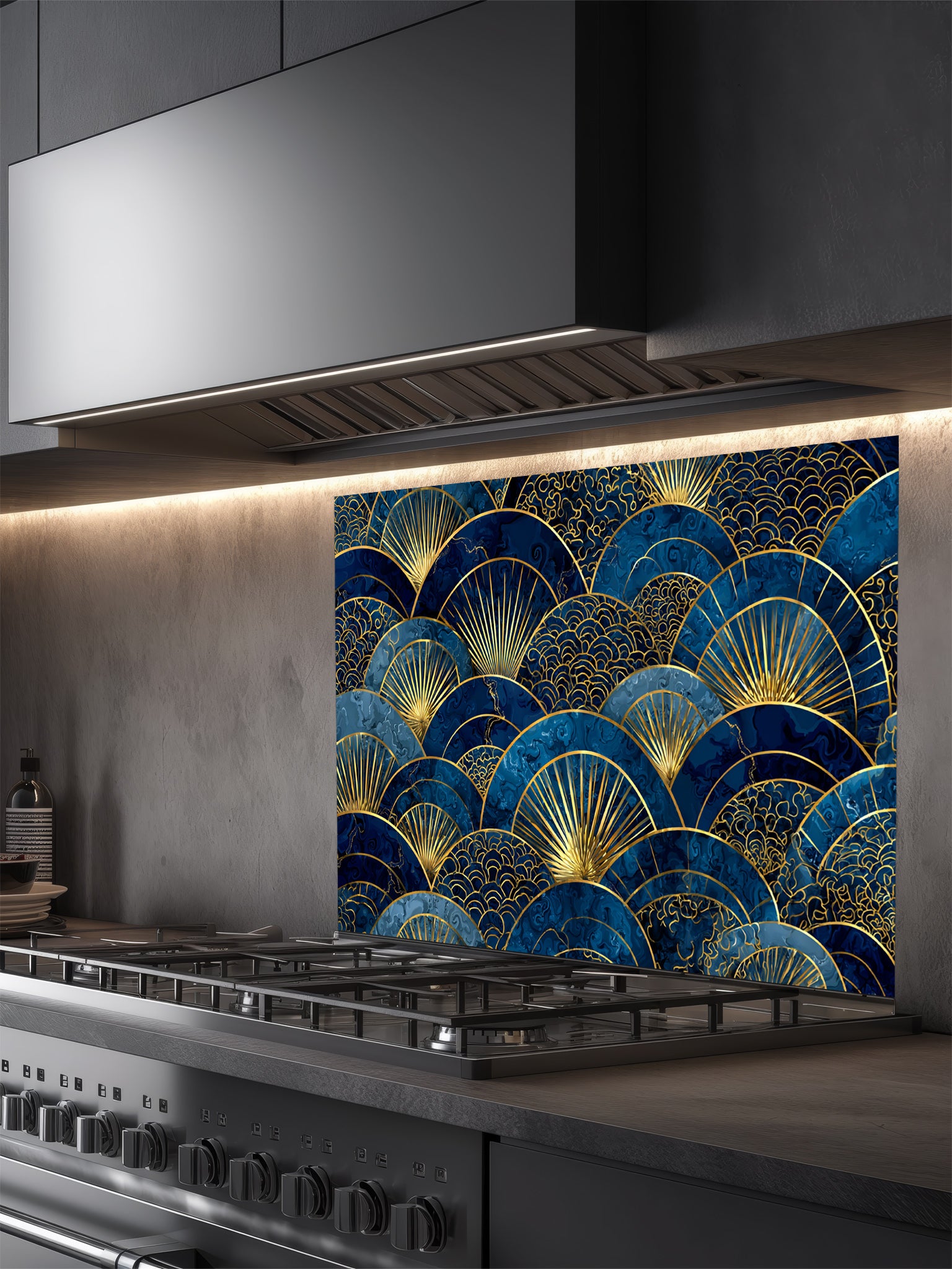 Intricate Japanese Seigaiha wave and Art Deco sunburst fan pattern in deep navy blue and gold, UV printed on a smooth tempered glass kitchen backsplash, installed behind a modern stove.