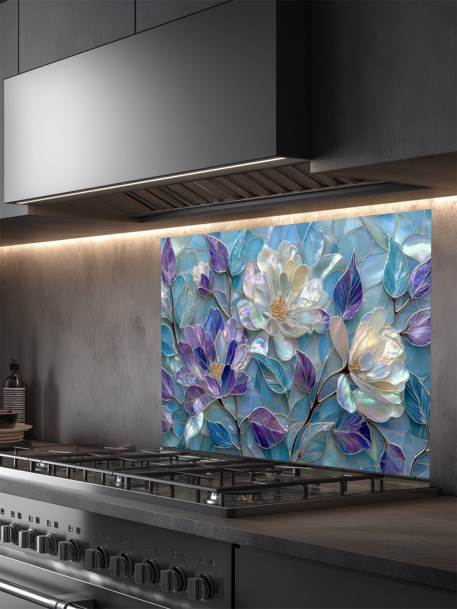 Tempered glass kitchen backsplash featuring a highly realistic 3D illusion of stained glass and mother-of-pearl mosaic art, showing large, elegant blooming flowers in iridescent shades of pearlescent white, lavender, and purple with flowing aqua blue leaves, installed behind a modern black stove.