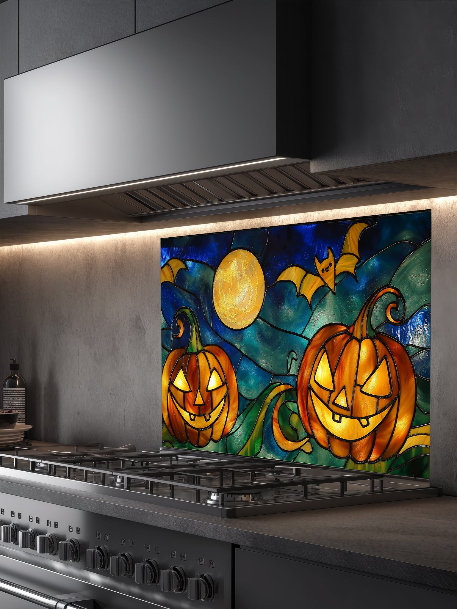 Decorative glass panel with Halloween design above a stove