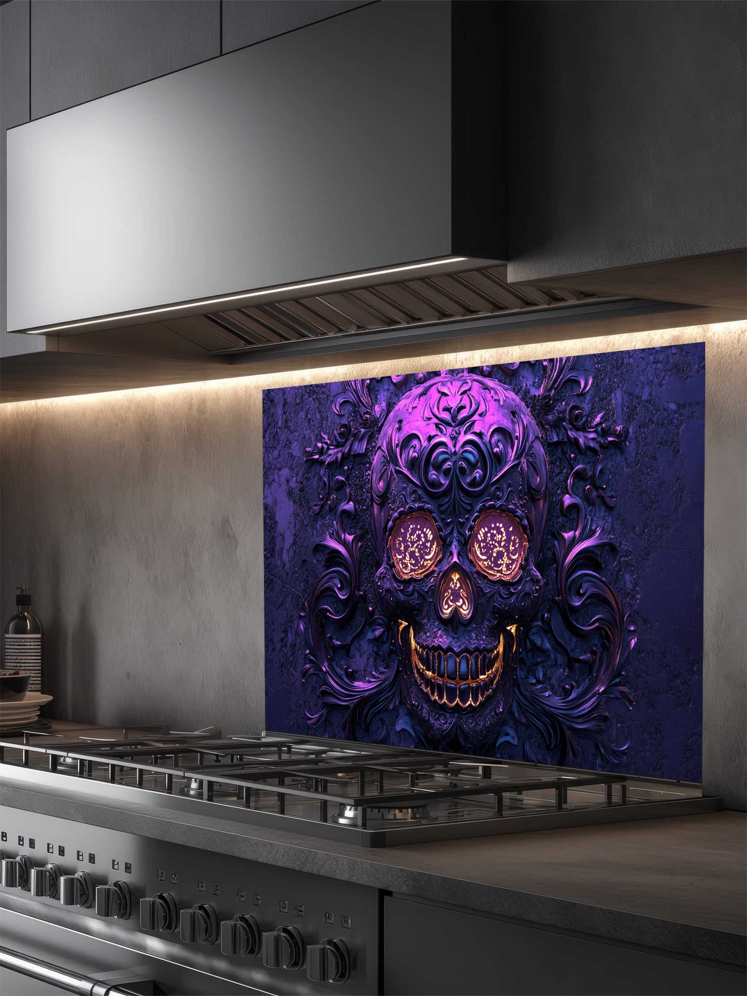Tempered glass kitchen backsplash featuring a highly realistic 3D illusion of an embossed, intricately carved gothic skull with glowing gold eyes and teeth, surrounded by dark purple baroque filigree swirls, installed behind a modern black stove.