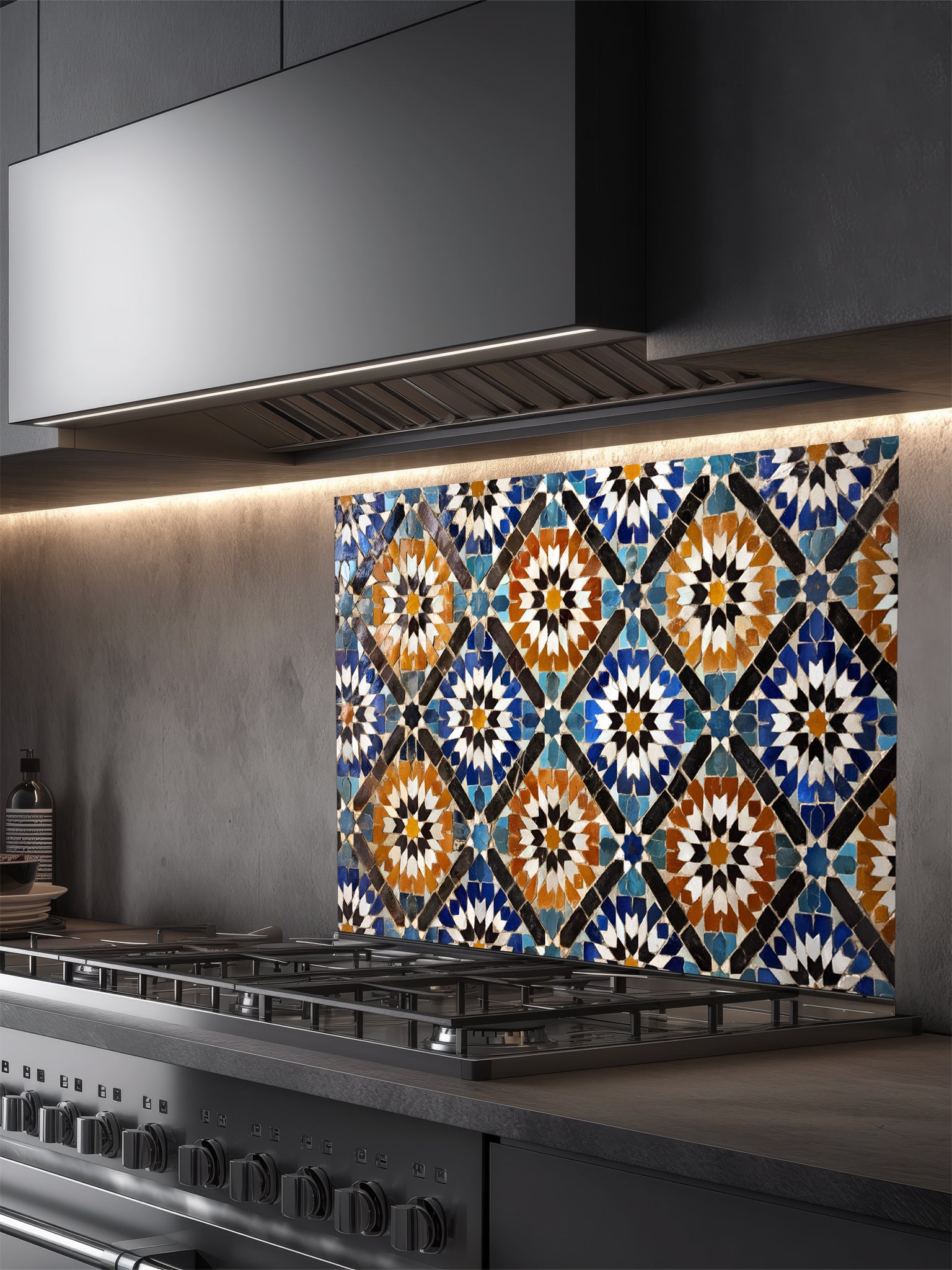 Decorative glass splashback with geometric pattern above a kitchen stove.
