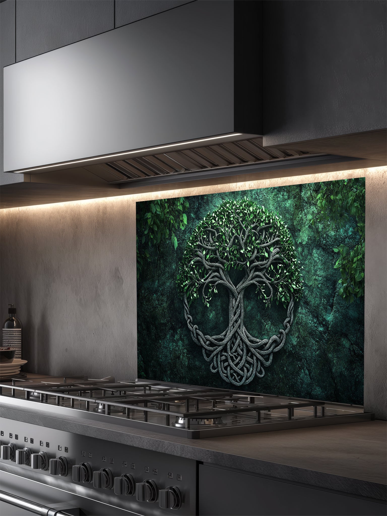 Tempered glass kitchen backsplash featuring a highly realistic 3D illusion of an ancient carved Celtic Tree of Life (Yggdrasil) with intricate knotwork roots and lush green leaves against a dark, moody forest green background, installed behind a modern black stove.