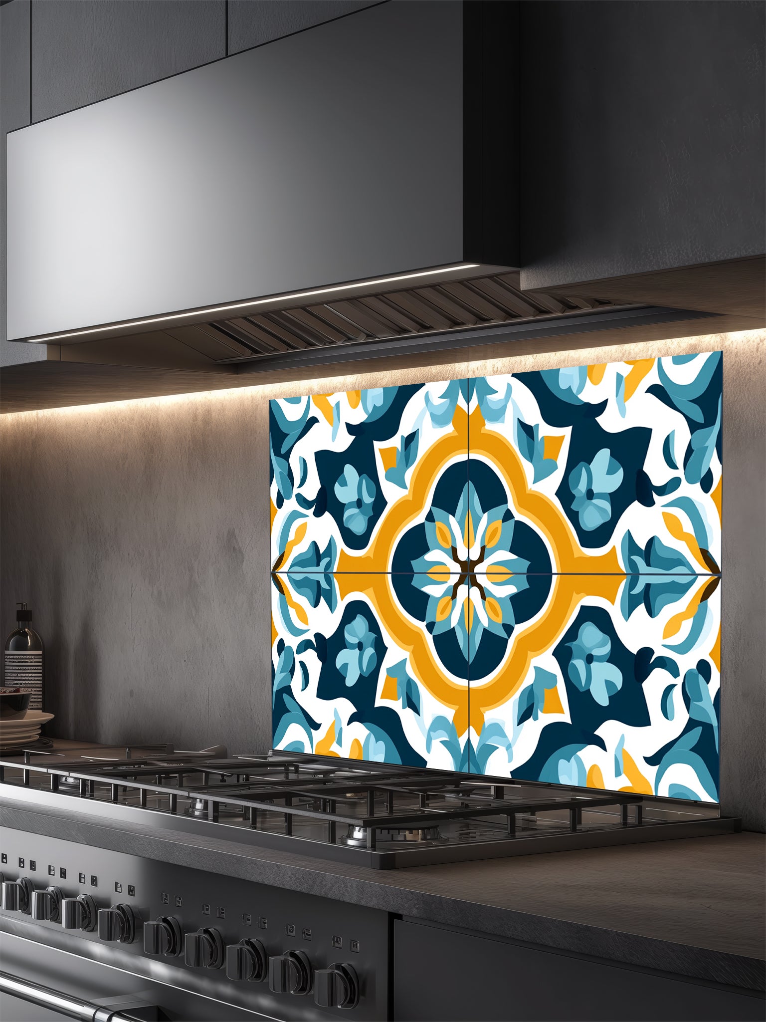 Tempered glass kitchen backsplash featuring a highly realistic illusion of traditional Mediterranean or Portuguese Azulejo tiles, showcasing a bold geometric floral pattern in vibrant teal, yellow, and navy blue on a crisp white background, installed behind a modern black stove.