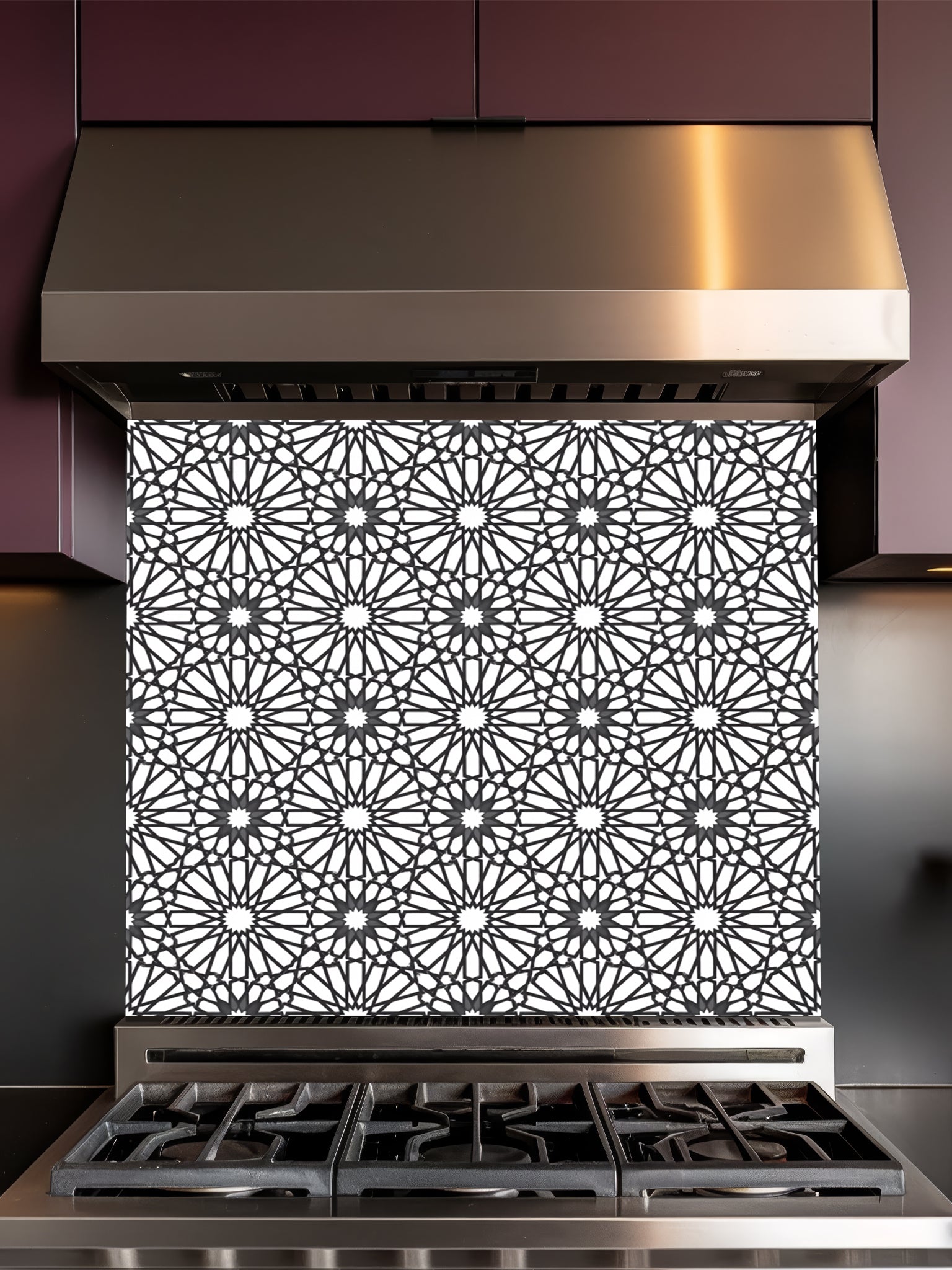 Decorative backsplash with geometric pattern above a stove in a kitchen.
