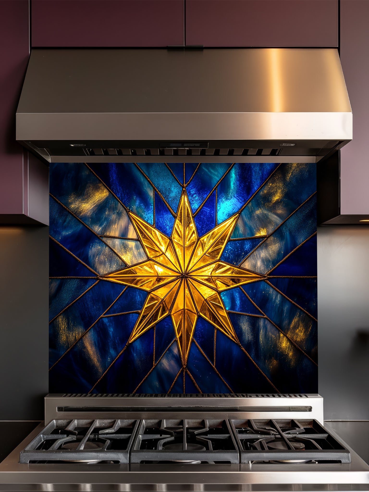 Tempered glass kitchen backsplash featuring a highly realistic 3D illusion of stained glass art showing a brilliant, glowing golden starburst or compass rose radiating against a deep sapphire blue background with faux gold lead lines, installed behind a modern stainless steel stove.
