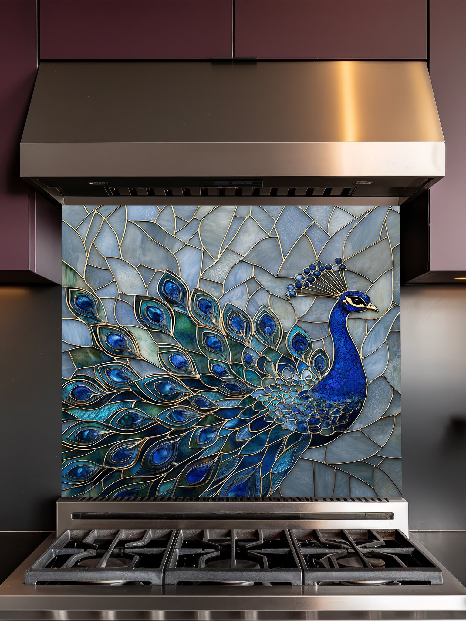 Tempered glass kitchen backsplash featuring a highly realistic 3D illusion of a stained glass mosaic showing a regal royal blue peacock with elegant gold outlines against an icy blue background, installed behind a modern stainless steel stove.
