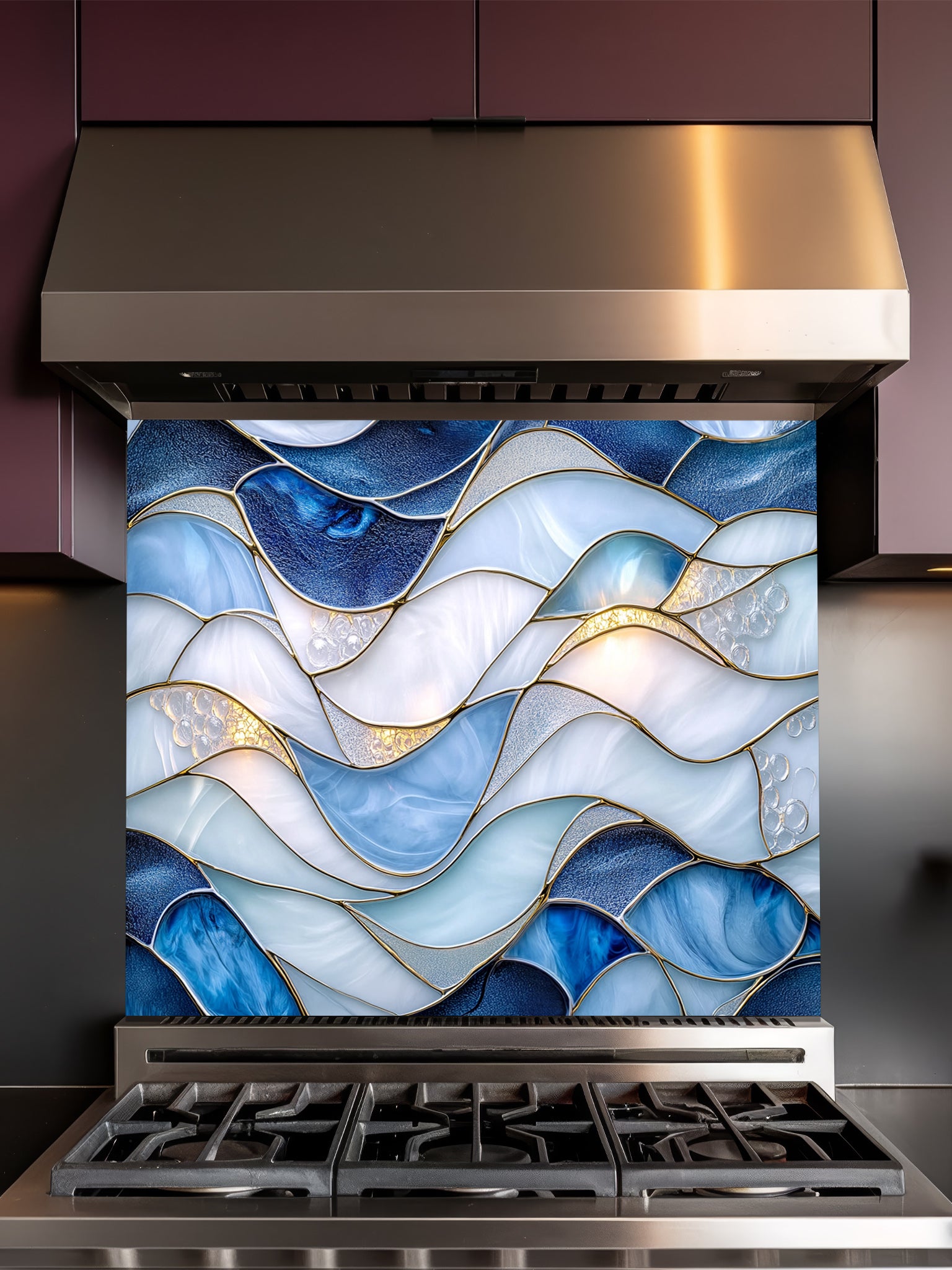 A modern kitchen featuring a tempered glass backsplash with a luxurious abstract fluid art design of blue and white waves with 3D-effect gold veins, installed behind a stainless steel stove.