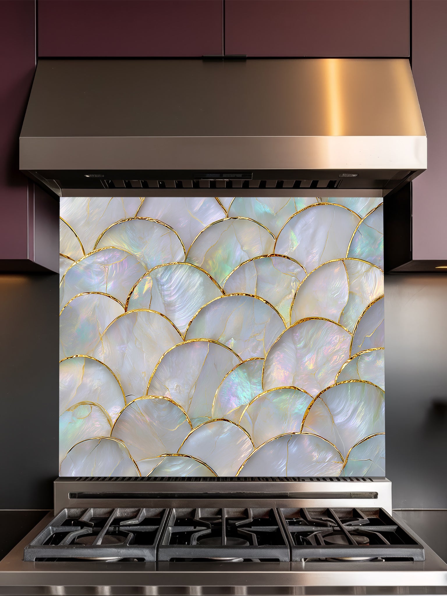 Stainless steel range hood with decorative glass splashback featuring shell pattern