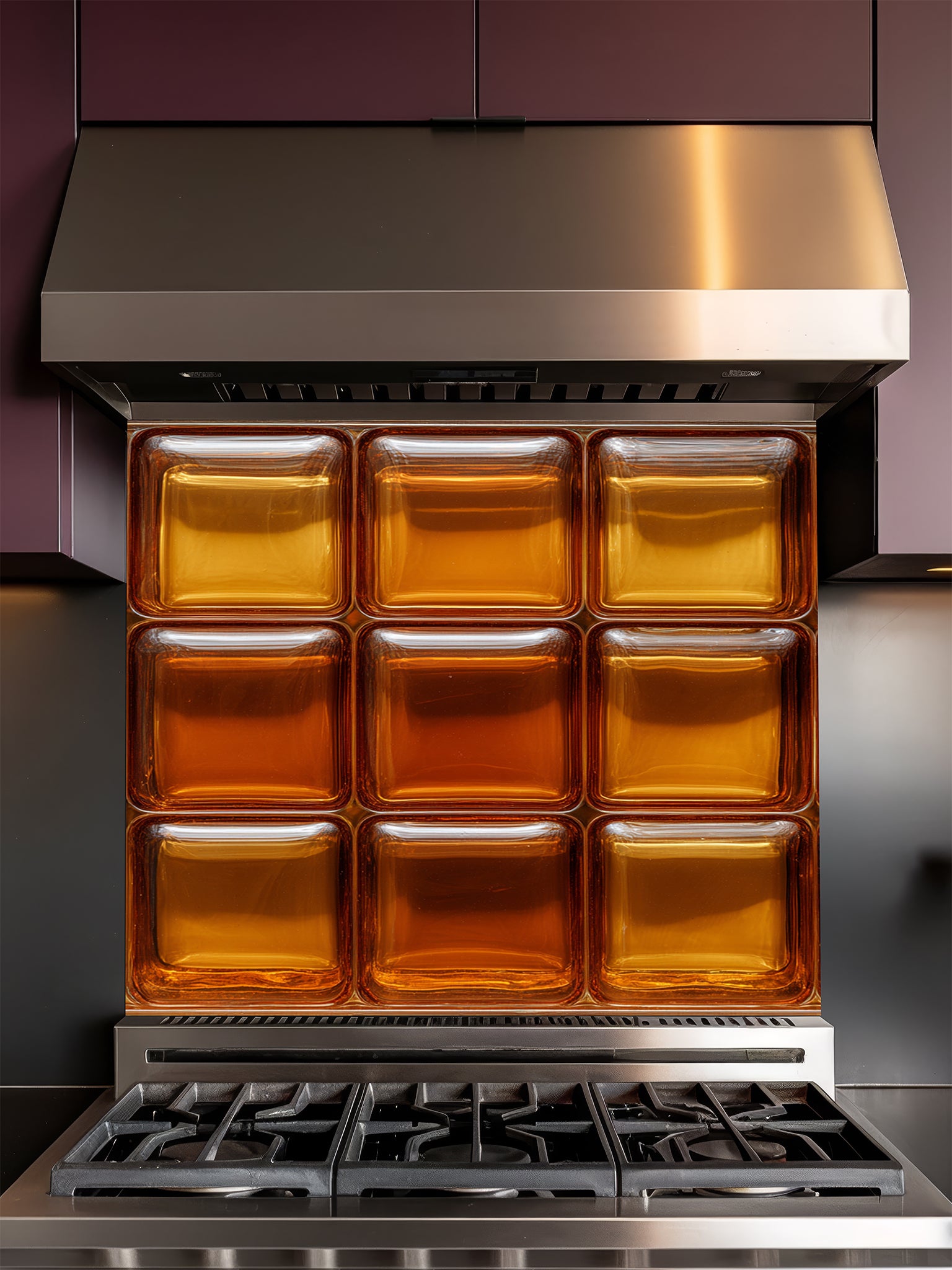 Tempered glass kitchen backsplash featuring a highly realistic 3D illusion of textured retro glass blocks in glowing, warm shades of amber and honey gold, installed behind a modern stainless steel stove.