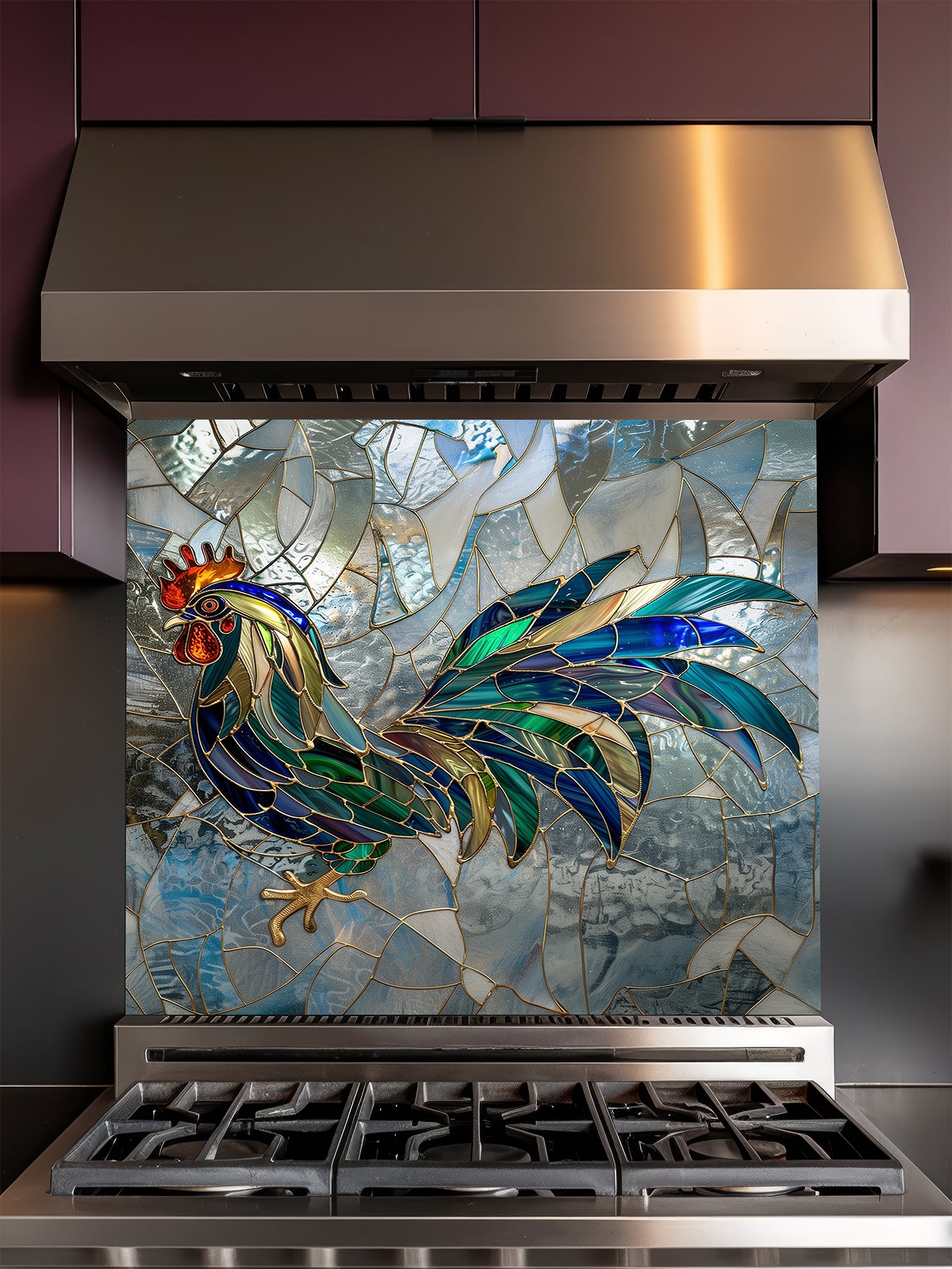 Tempered glass kitchen backsplash featuring a faux stained glass design of a rooster with teal, emerald, and navy feathers and prominent gold outlines, set against an abstract icy blue mosaic background, installed behind a modern stainless steel stove.