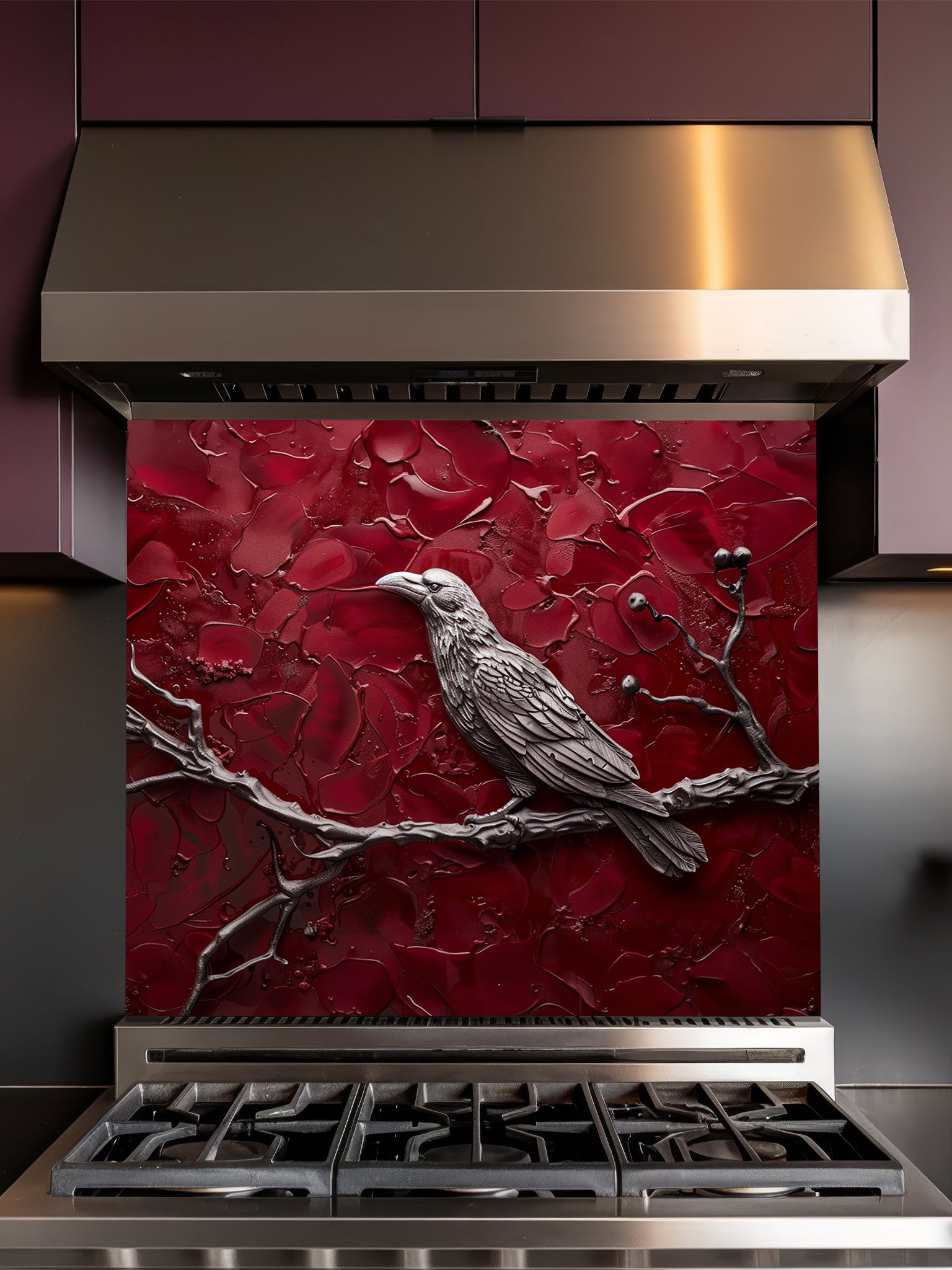 Tempered glass kitchen backsplash featuring a highly realistic 3D illusion of a sculpted metallic raven perched on a branch with berries against a heavily textured, thick impasto crimson red background, installed behind a modern black stove.