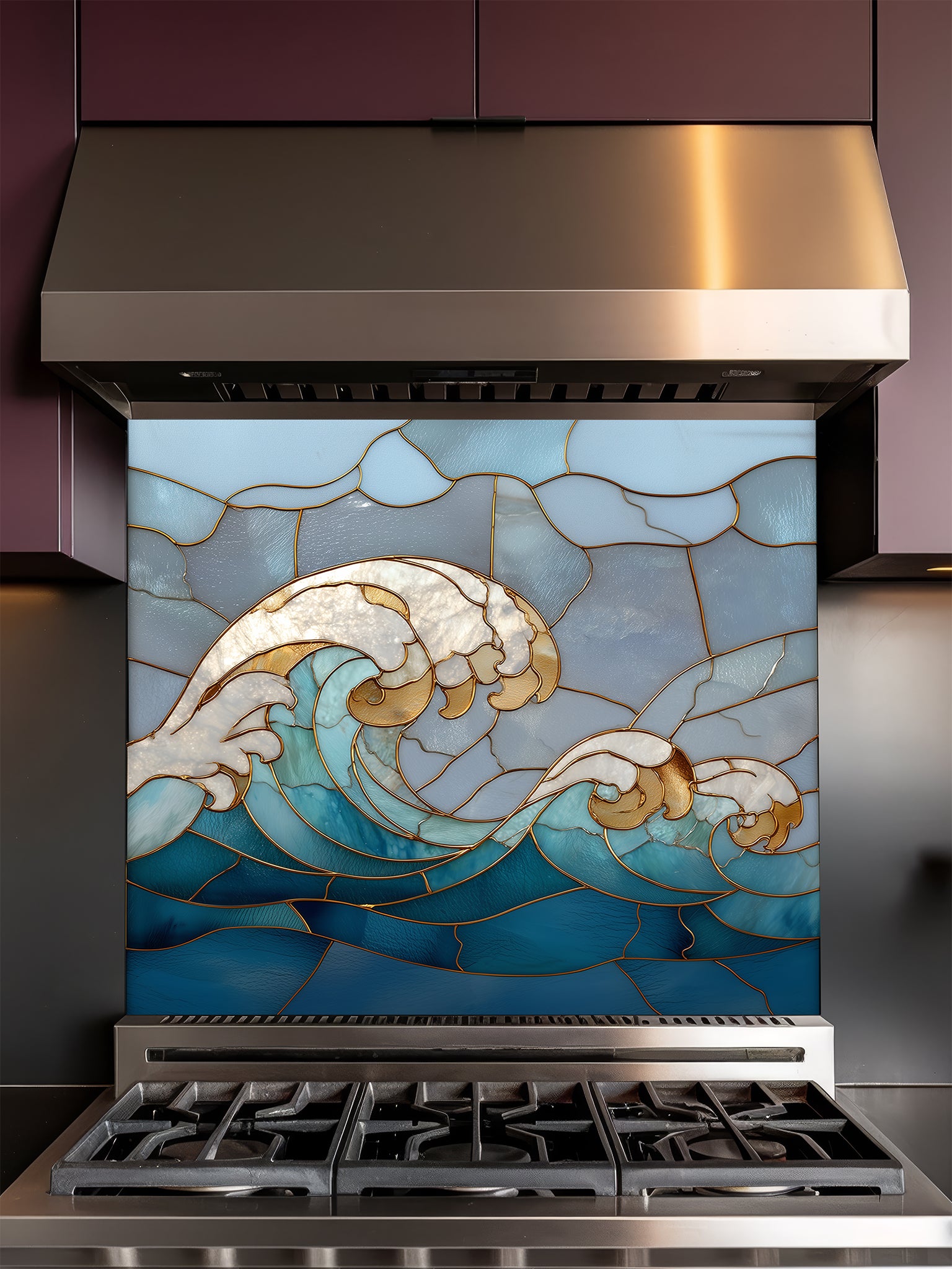 Tempered glass kitchen backsplash featuring a dramatic crashing ocean wave design in faux stained glass with deep blue water, white foam crests, and elegant gold outlines, installed behind a modern stainless steel stove.