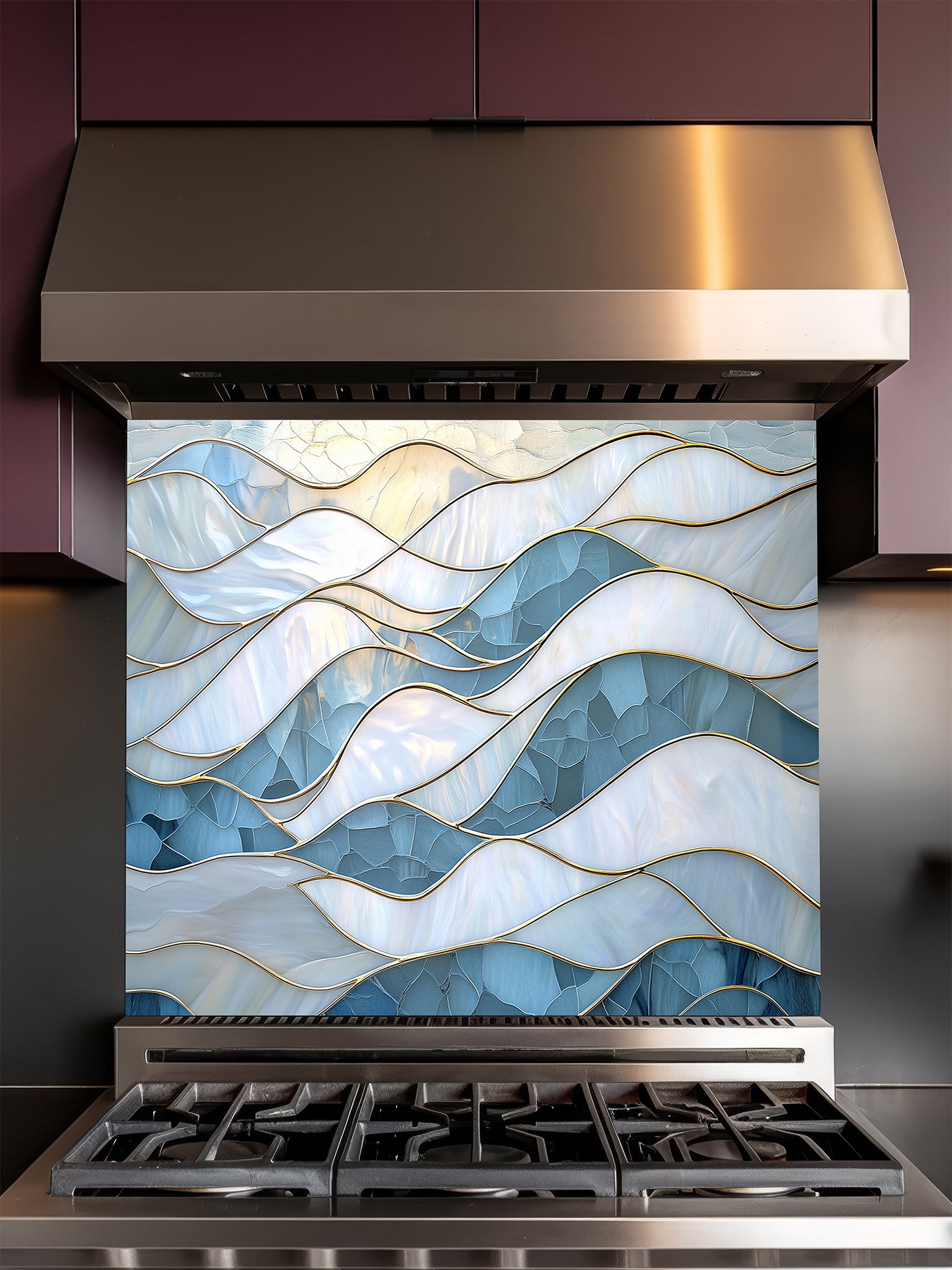 Tempered glass kitchen backsplash featuring a serene faux stained glass design of layered, flowing waves in icy blue and pearlescent white, separated by elegant gold outlines, installed behind a modern stainless steel stove.