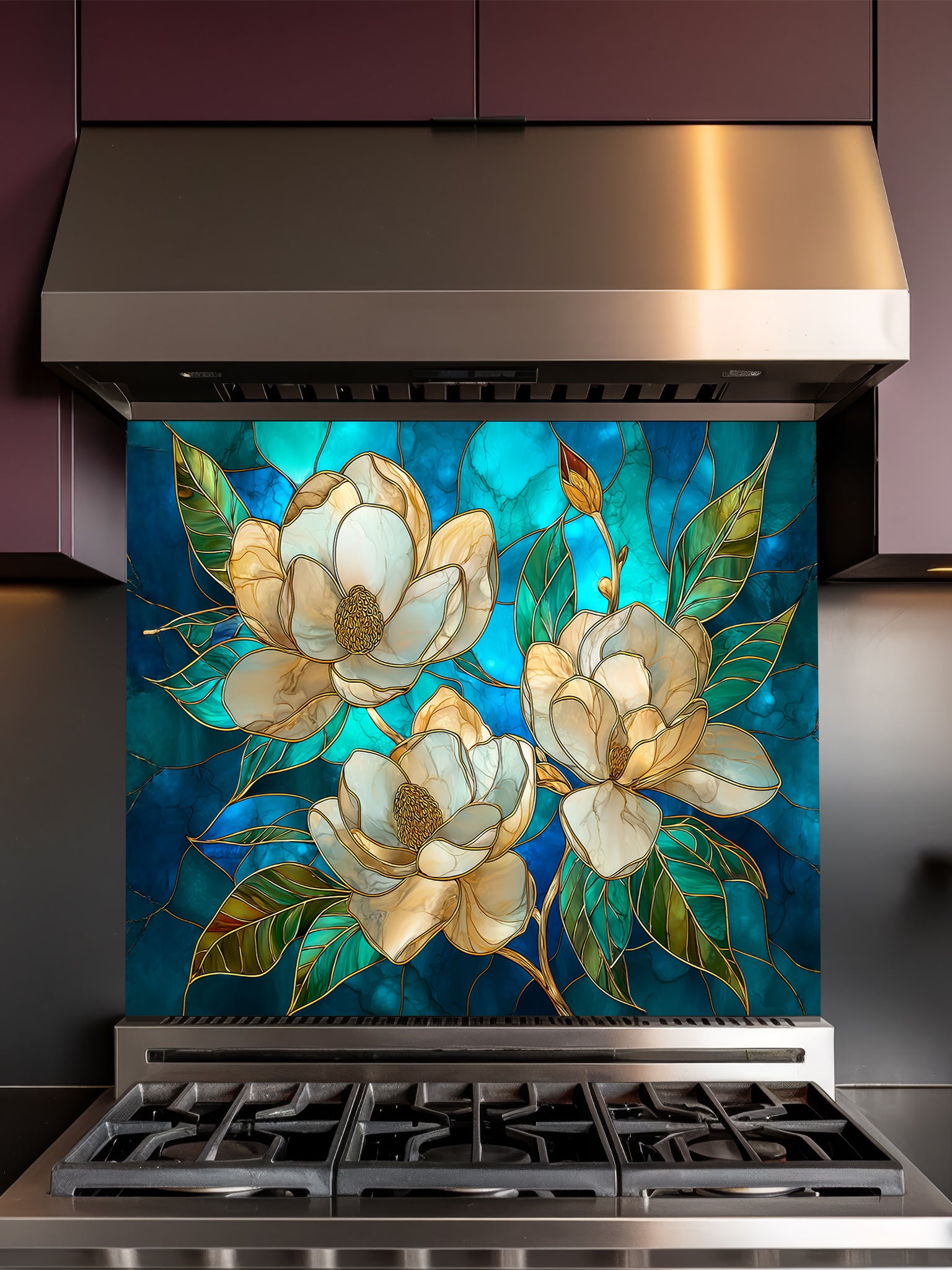 Tempered glass kitchen backsplash featuring a highly realistic 3D illusion of stained glass art showing elegant white magnolia blossoms with gold outlines against a swirling deep blue and teal background, installed behind a modern stainless steel stove.