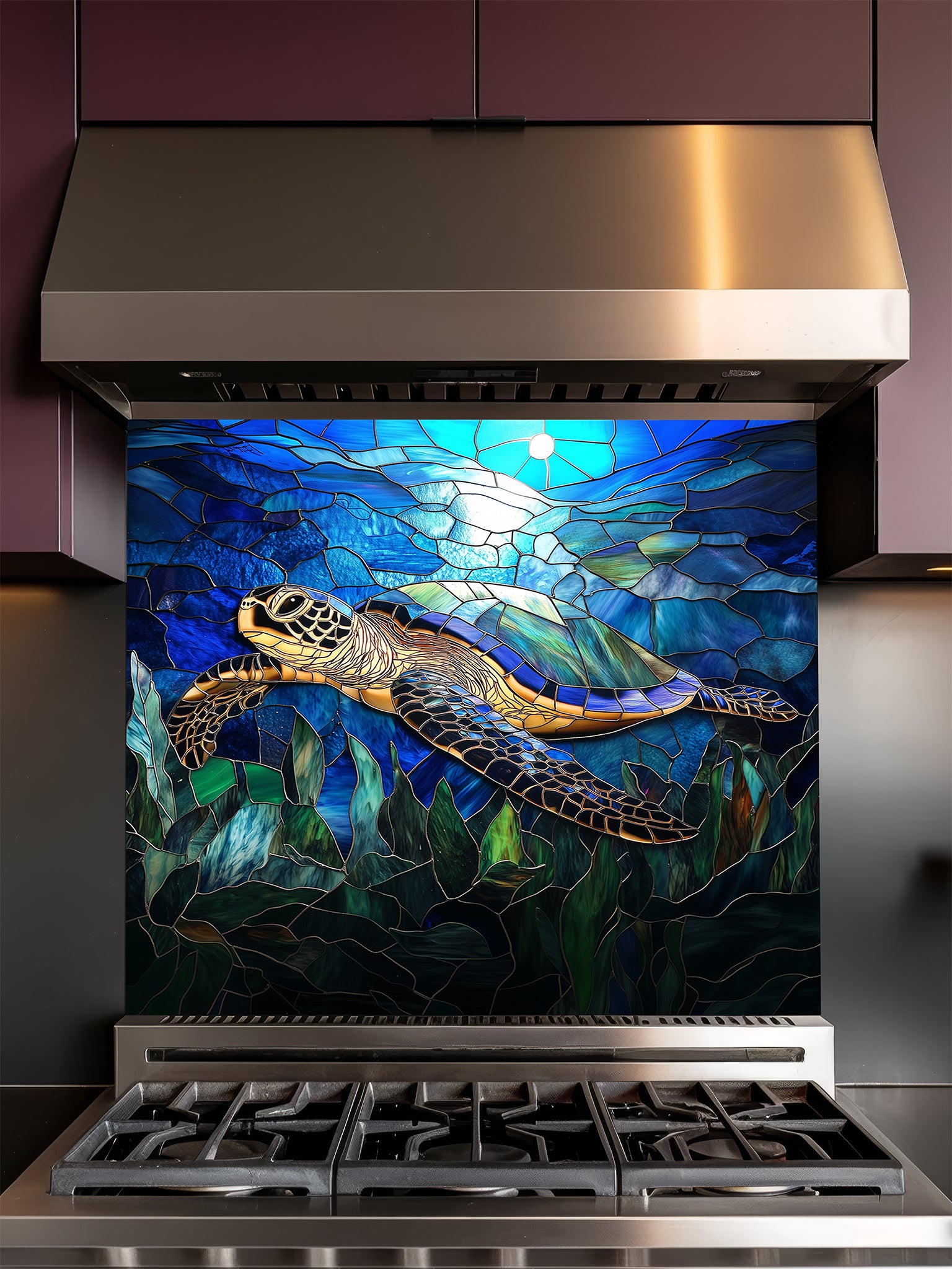 Tempered glass kitchen backsplash featuring a vibrant faux stained glass design of a graceful sea turtle swimming against a luminous blue sunlit ocean and cracked mosaic background, installed behind a modern stainless steel stove.