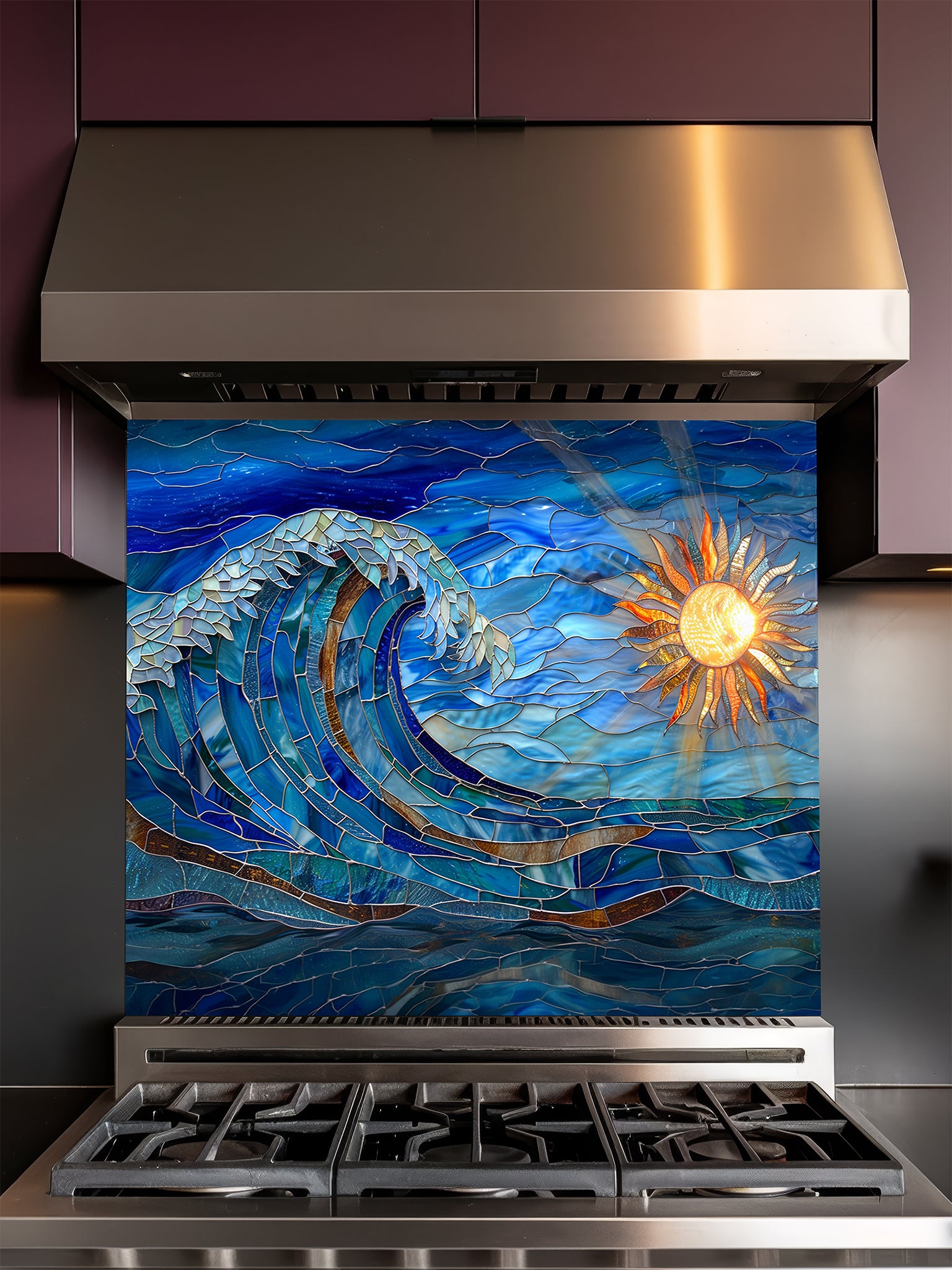 Tempered glass kitchen backsplash featuring a vibrant faux stained glass design of a dynamic crashing ocean wave in blues and teals, with a glowing golden sun and sunbeams on the right, installed behind a modern stainless steel stove.