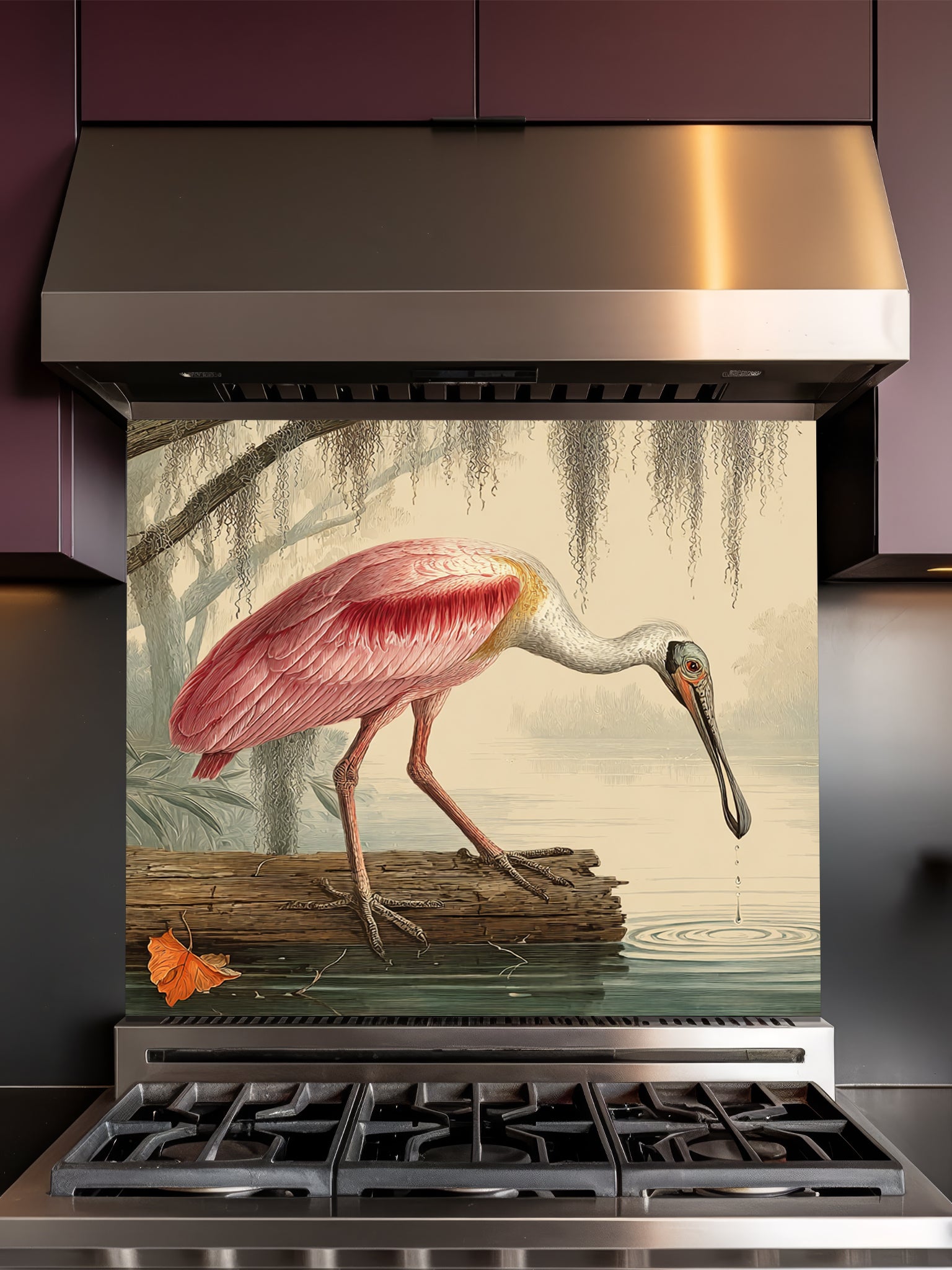 Tempered glass kitchen backsplash featuring a highly realistic illusion of a vintage Audubon-style naturalist illustration showing a beautiful pink roseate spoonbill bird wading in a swamp with weeping Spanish moss against an aged parchment background, installed behind a modern black stove.