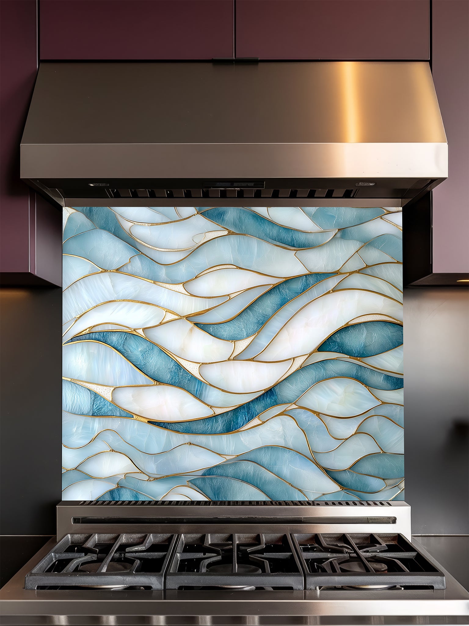 Tempered glass kitchen backsplash featuring a calming modern abstract wave design in faux stained glass with blue, teal, and pearlescent white sections separated by elegant gold lines, installed behind a modern stainless steel stove.