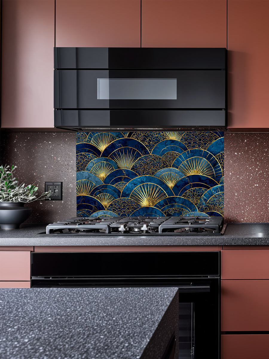Intricate Japanese Seigaiha wave and Art Deco sunburst fan pattern in deep navy blue and gold, UV printed on a smooth tempered glass kitchen backsplash, installed behind a modern stove.