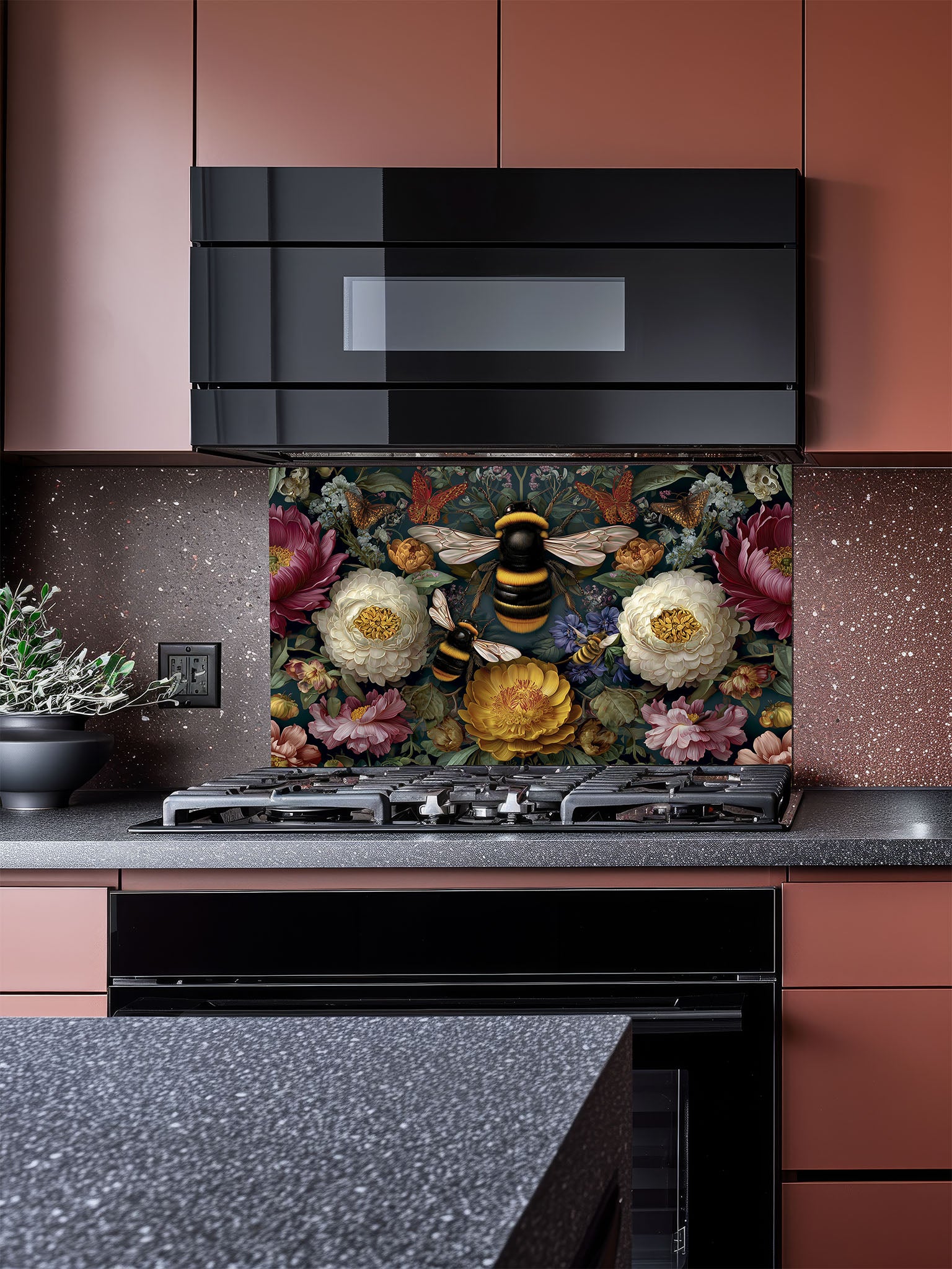 Tempered glass kitchen backsplash featuring a dark moody floral and large bumblebee vintage design installed behind a modern stainless steel stove.