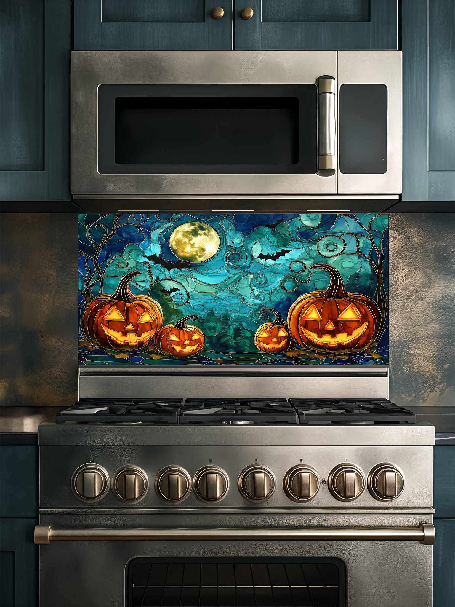 Stainless steel oven with Halloween-themed glass backsplash featuring pumpkins and a full moon.