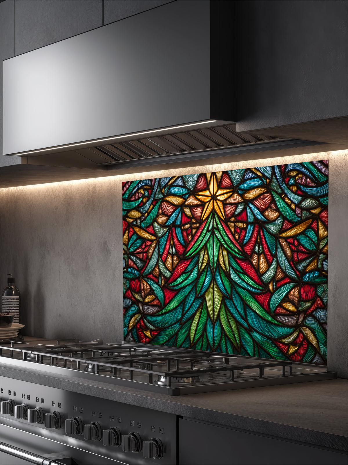 Tempered glass kitchen backsplash featuring a highly realistic 3D illusion of stained glass art showing a vibrant, symmetrical geometric Christmas tree with a glowing gold star at the top in rich jewel tones of emerald green, ruby red, and amber, installed behind a modern black stove.