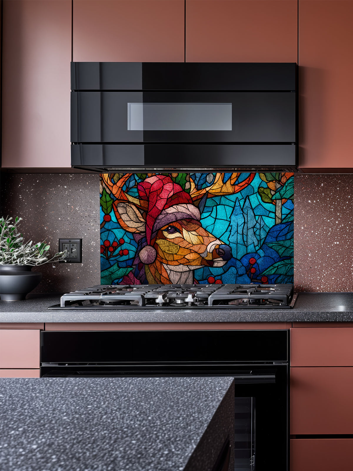Tempered glass kitchen backsplash featuring a highly realistic 3D illusion of stained glass and mosaic art showing a festive reindeer wearing a red Santa hat in a frosty blue winter forest with holly berries, installed behind a modern black stove.