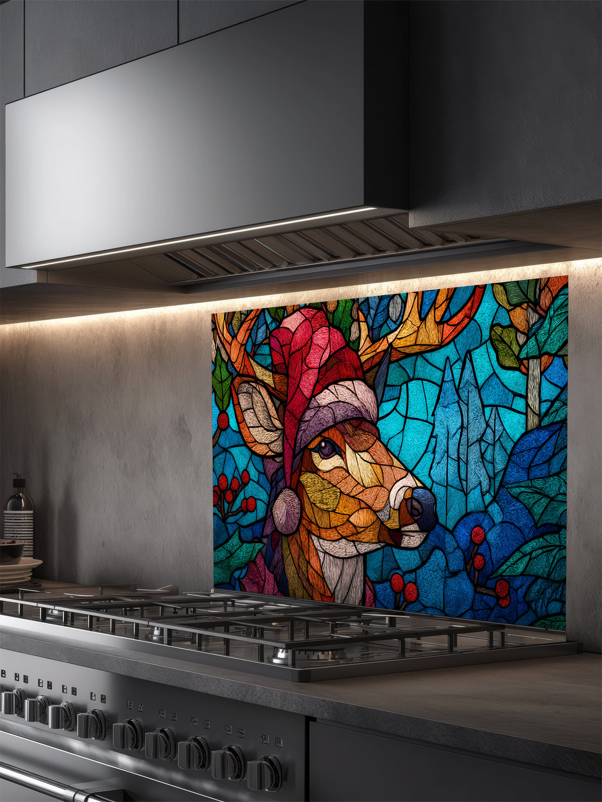 Tempered glass kitchen backsplash featuring a highly realistic 3D illusion of stained glass and mosaic art showing a festive reindeer wearing a red Santa hat in a frosty blue winter forest with holly berries, installed behind a modern black stove.