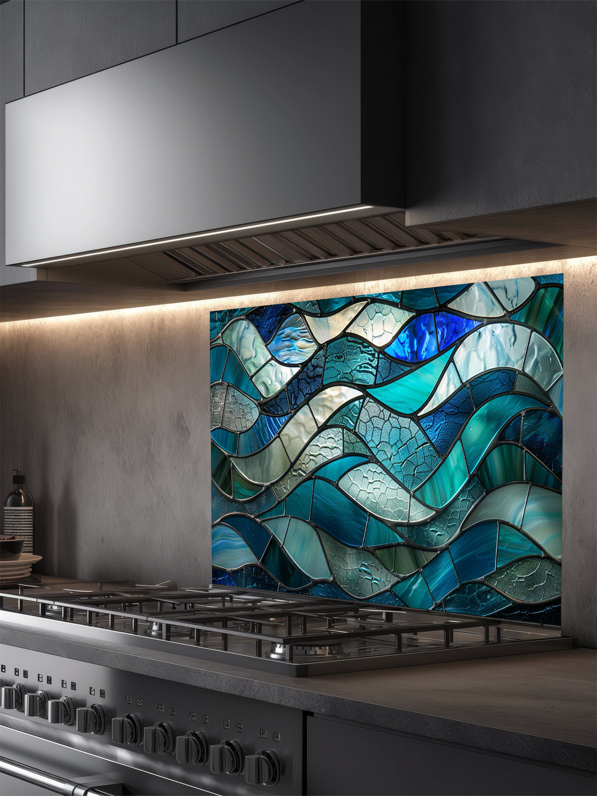 Tempered glass kitchen backsplash featuring a highly realistic 3D illusion of stained glass or sea glass art showing flowing, overlapping ocean waves in vibrant translucent shades of sapphire blue, teal, and aquamarine, installed behind a modern black stove.