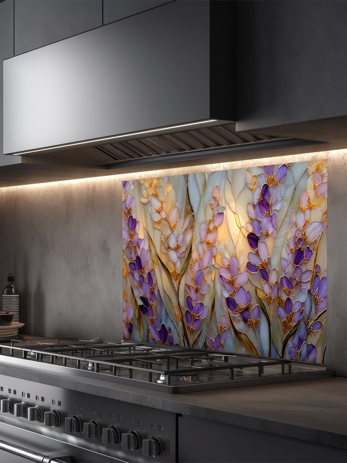 Tempered glass kitchen backsplash featuring a highly realistic 3D illusion of Art Nouveau stained glass art showing elegant, sweeping clusters of purple lavender and lilac blossoms with green leaves outlined in gold against a warm amber background, installed behind a modern black stove.
