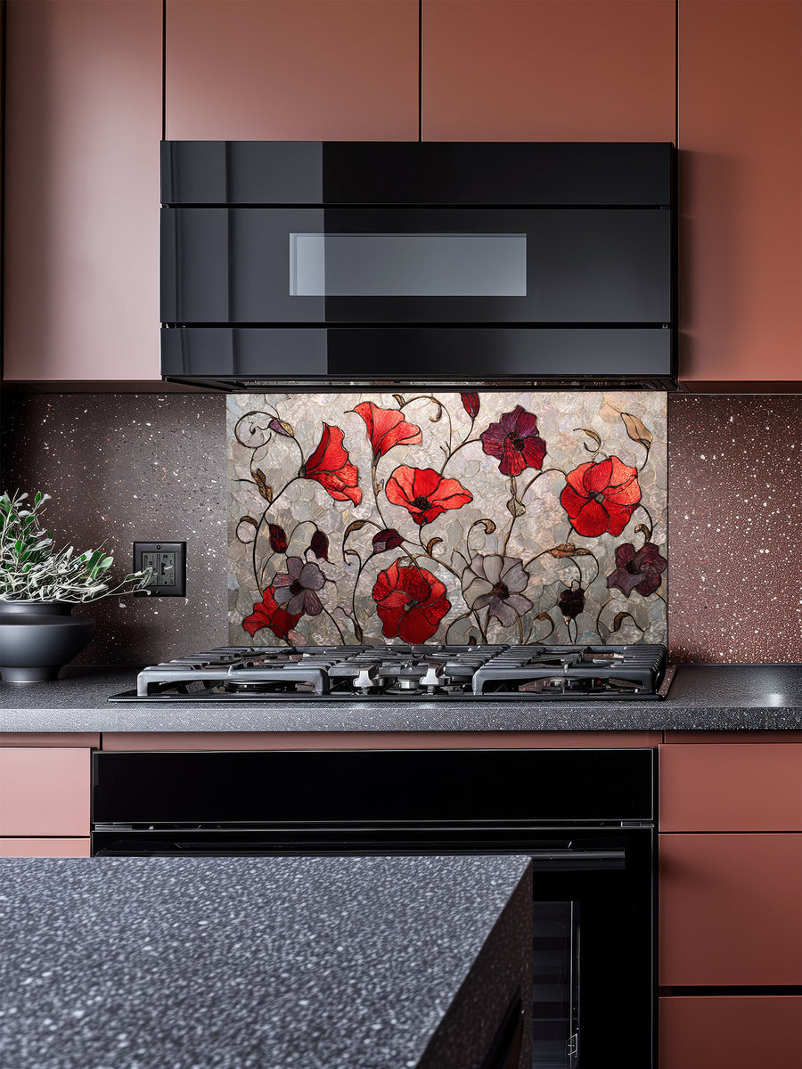 Tempered glass kitchen backsplash featuring a faux stained glass design of vibrant red and purple poppy flowers with elegant curving stems against a textured silver mosaic background, installed behind a modern stainless steel stove.