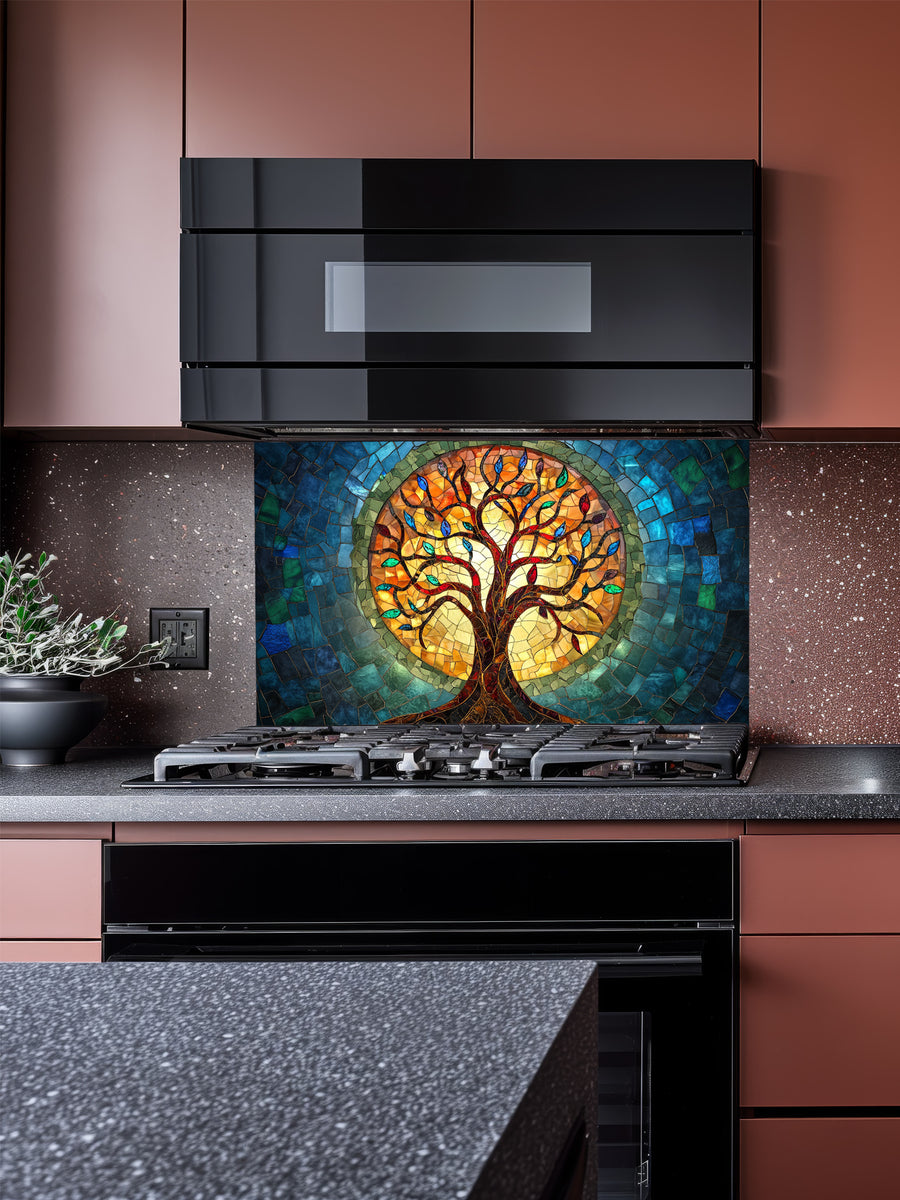 Stained glass mosaic style Tree of Life with vibrant blue, teal, and glowing amber colors, UV printed on a smooth tempered glass kitchen backsplash, installed behind a modern stove.