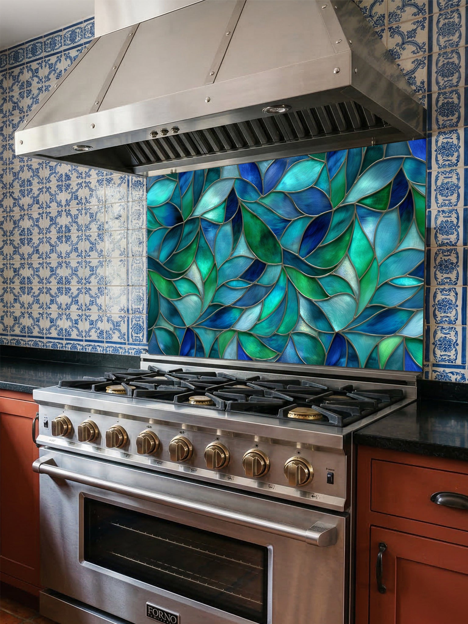 Tempered glass kitchen backsplash featuring a vibrant botanical stained glass effect with overlapping leaves in shades of teal, blue, and emerald green, installed behind a modern stainless steel stove.