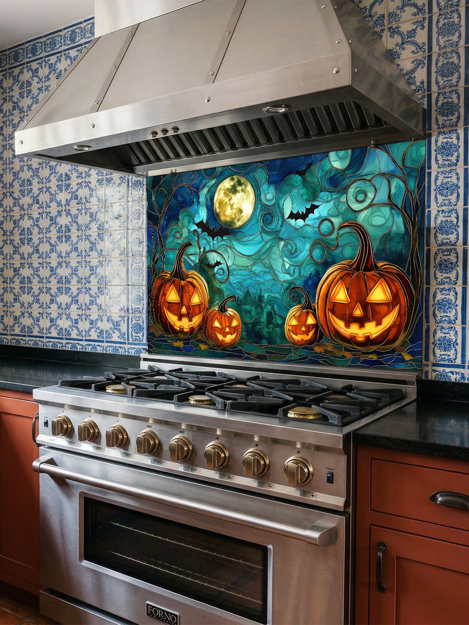 Stainless steel oven with Halloween-themed decorative backsplash featuring pumpkins and a full moon.
