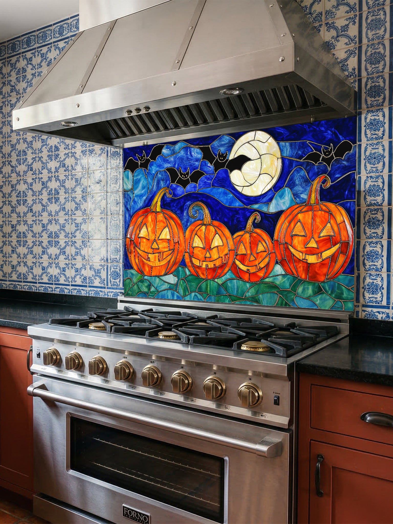 Stainless steel oven with a decorative backsplash featuring pumpkins and bats.