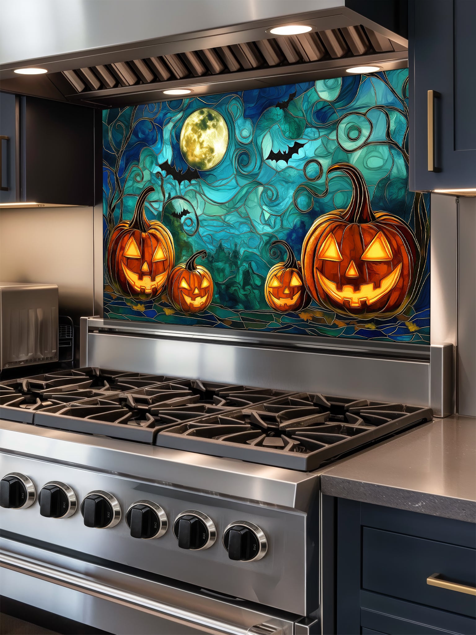 Stainless steel stove with a decorative backsplash featuring pumpkins and a moon.