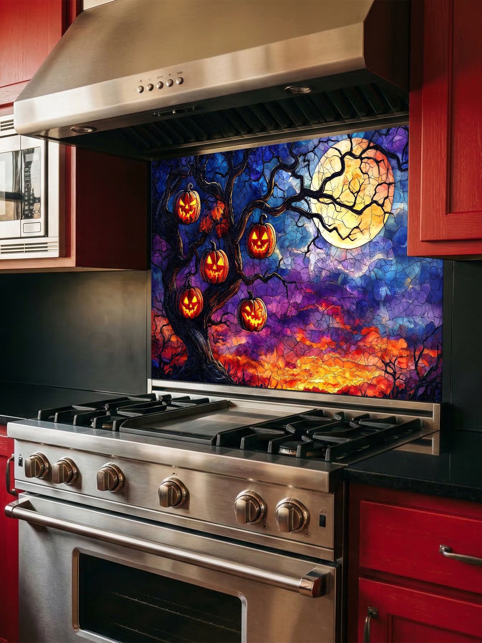 Stainless steel oven with a colorful Halloween-themed backsplash featuring pumpkins and a full moon.