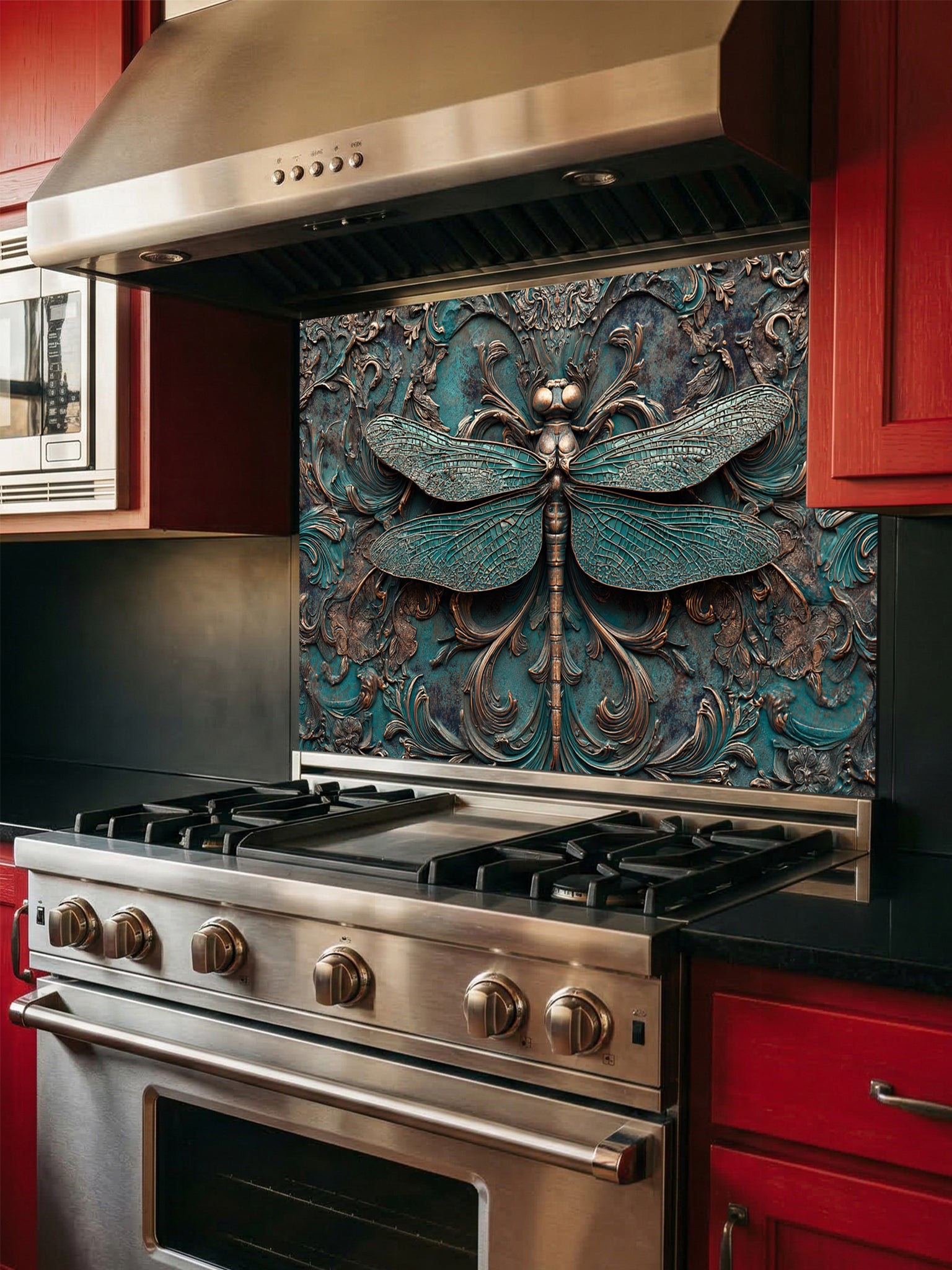 Tempered glass kitchen backsplash featuring a highly realistic 3D faux metal relief design of a detailed dragonfly and ornate antique bronze baroque scrollwork over a textured oxidized teal background, installed behind a modern stainless steel stove.