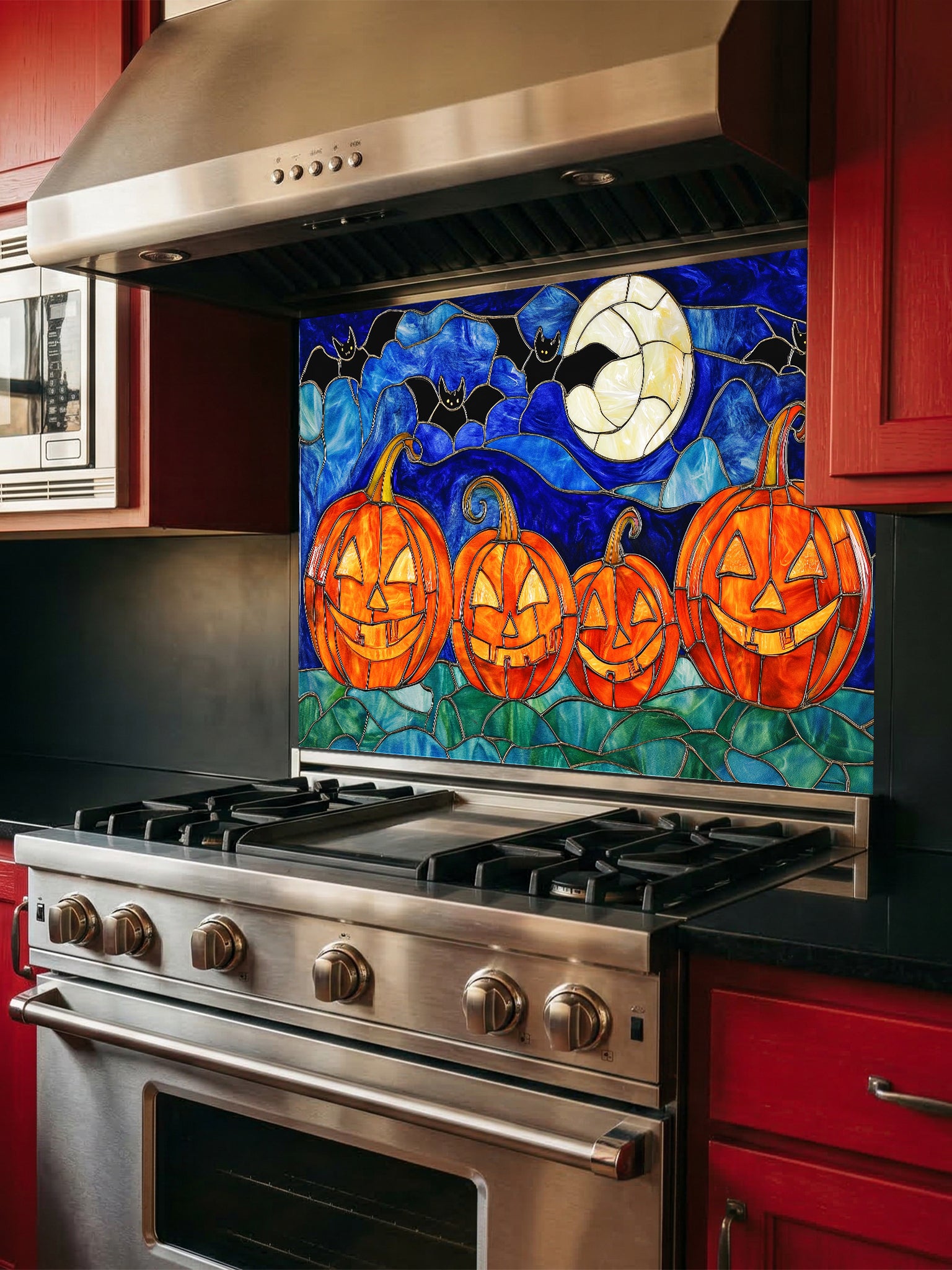 Decorative backsplash with pumpkins and moon design above a stove in a kitchen.