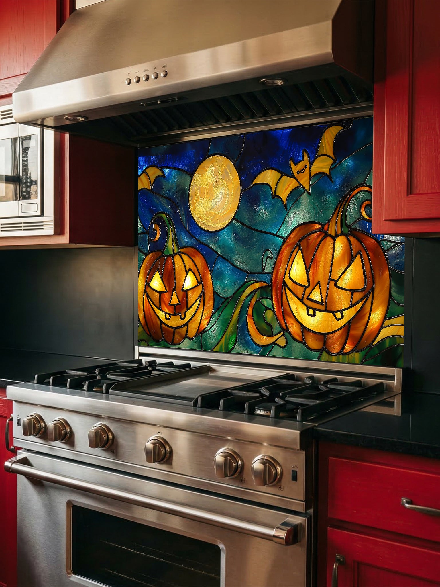 Stainless steel stove with a colorful Halloween-themed backsplash featuring pumpkins and bats.