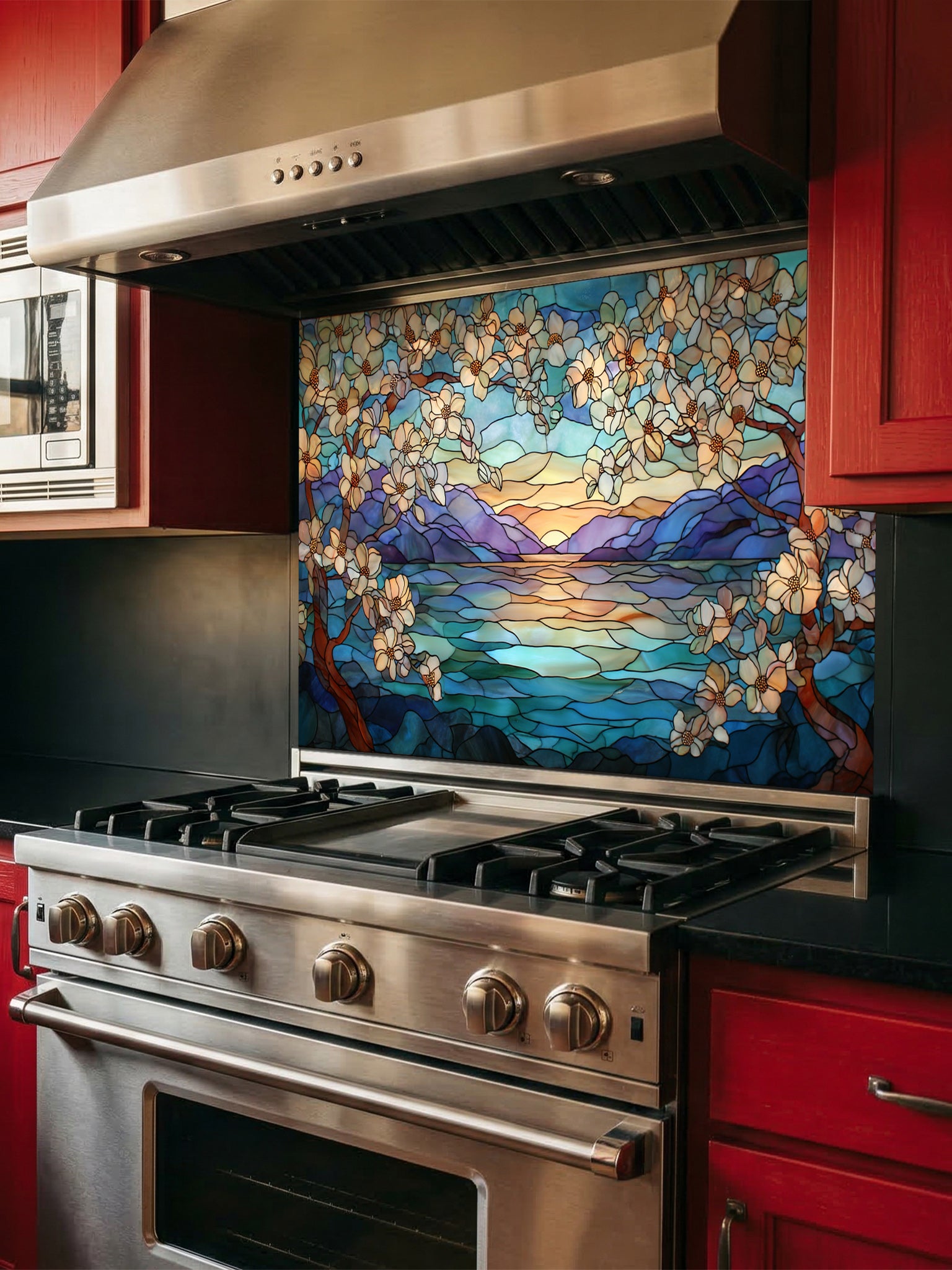 A modern kitchen featuring a tempered glass backsplash with a beautiful stained glass effect landscape, showing blooming trees, a mountain lake, and a sunset, installed behind a stainless steel stove.