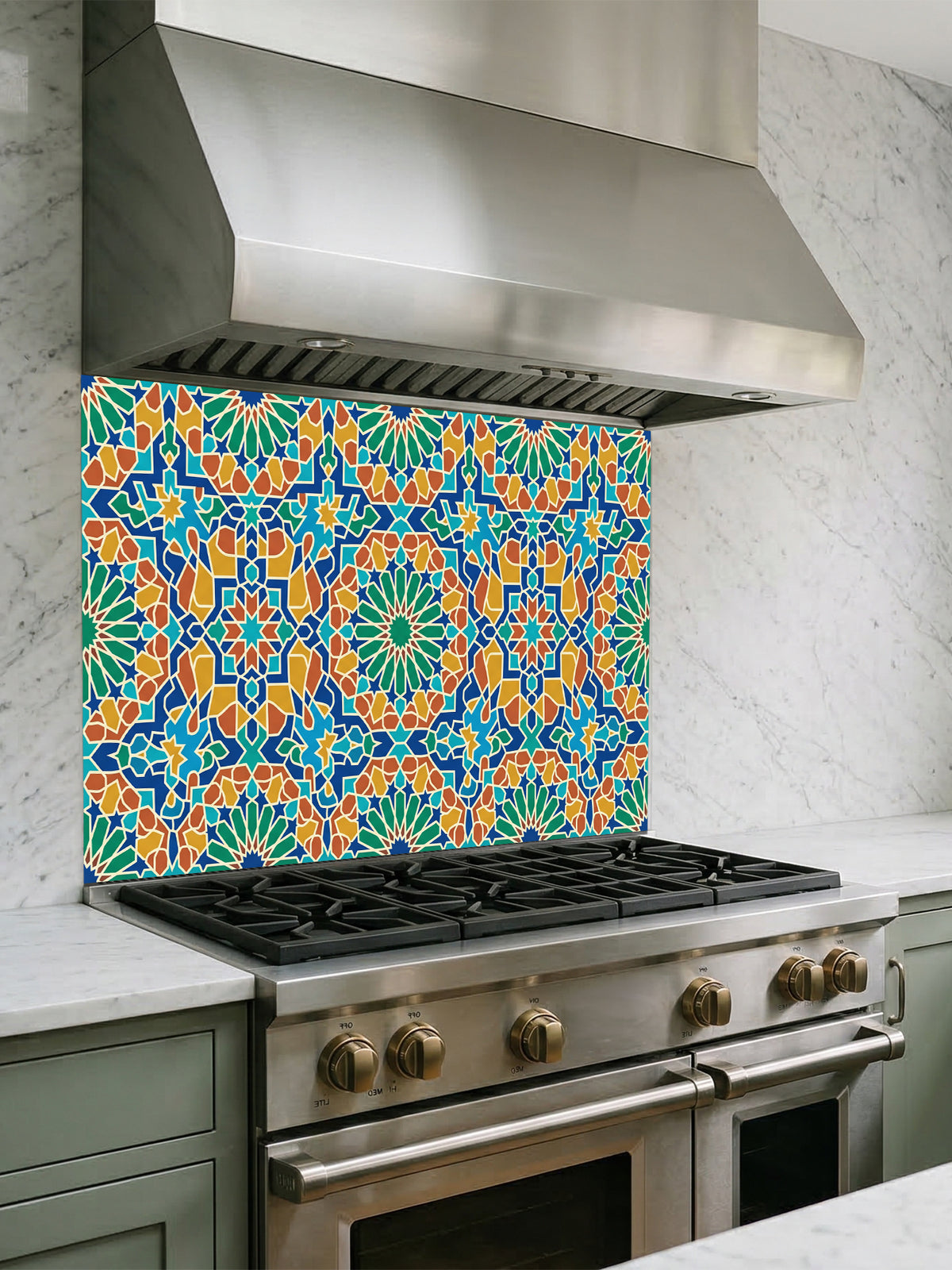 Stainless steel range hood above a gas stove with a colorful geometric patterned backsplash.